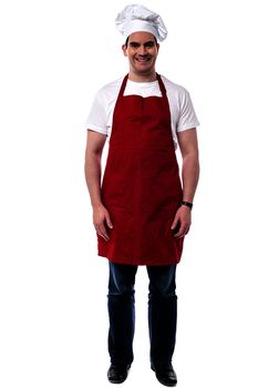 Full length of happy chef standing over white
