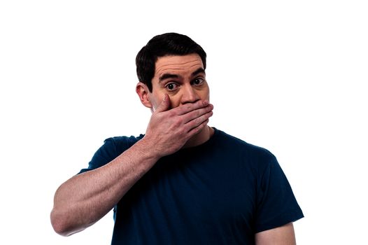 Shocked man covering mouth with hand