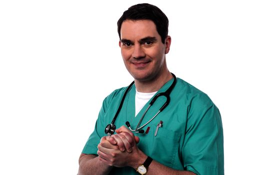 Male doctor posing with his hands clasped