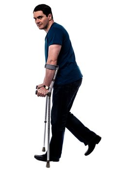 Side pose casual man walking with crutches