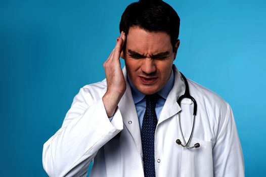 Male physician suffering from headache