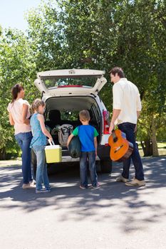 Happy family getting ready for road trip on a sunny day