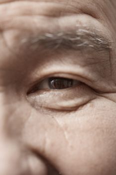 Face of elderly man looking at camera. Vertical photo