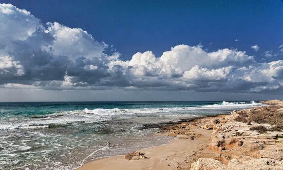 Seashore late autumn harsh and cold, heavy clouds hung over the waves