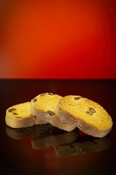 Three sweet crackers with raisins photographed in studio against a red background