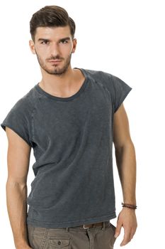 Handsome bearded young man with a lovely charismatic smile wearing a cotton t-shirt, isolated on white