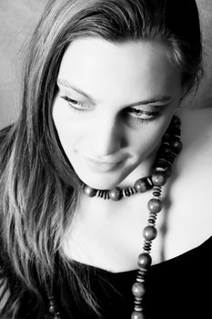 Beautiful female model wearing wooden beads and black top