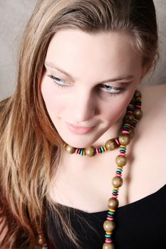 Beautiful female model wearing wooden beads and black top