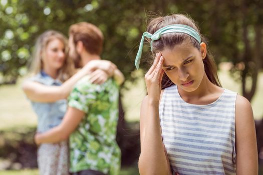 Brunette upset at seeing boyfriend with other girl on a summers day