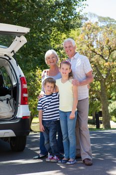 Grandparents going on road trip with grandchildren on a sunny day