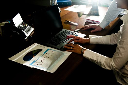 man and woman executives working on laptop to make a deal