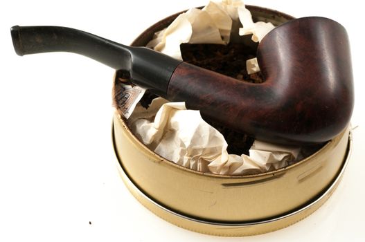 pipe with round box of tobacco and accessories