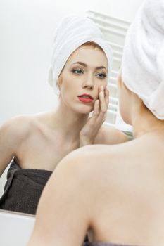 Close up Fresh Young Woman From Shower Looking her Face While Touching it In Front the Mirror