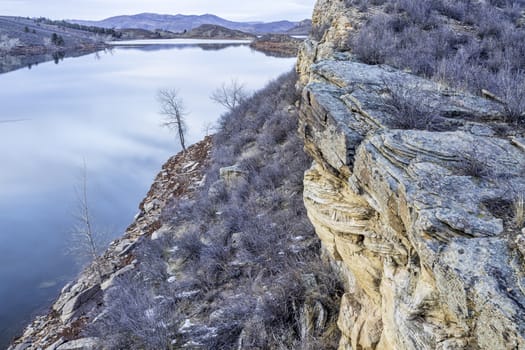 winter dusk over mountain lake with sandstone cliffs - Horsetooth Reservoir near Fort Collins, Colorado