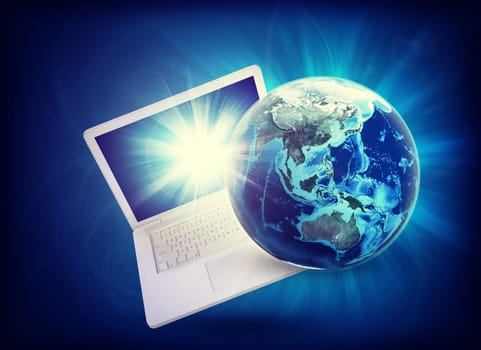 Earth model on laptop at angle on abstract blue background. Elements of this image furnished by NASA