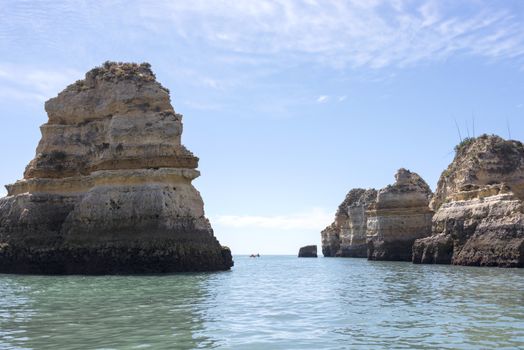 rocks and cliff with stairs and bridge in algarve city lagos in Portugal, the most beautifull coastline of the world seen from a boat