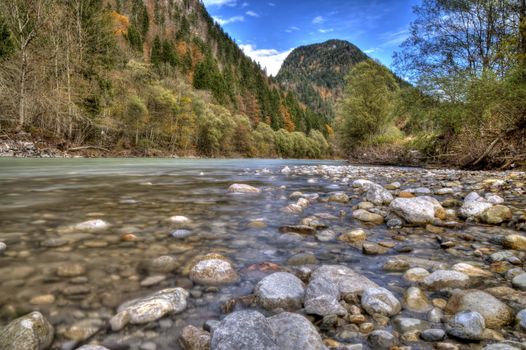 Rocks in the flowing river at the mountains