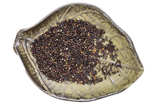 gluten free, black quinoa grain in a leaf shaped ceramic bowl, isolated on white