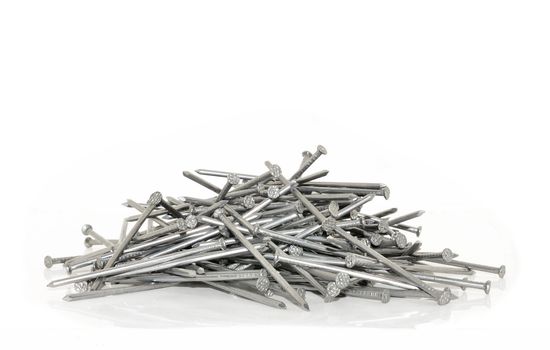 pile of metal nails in gray on a white background