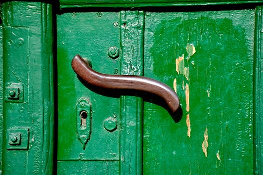Doorhandle on a green door