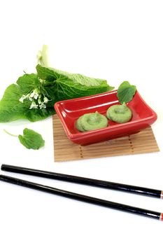 Wasabi with leaf and flower in a red bowl