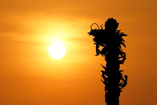  silhouette of  chinese dragon with beautiful sunset background          
