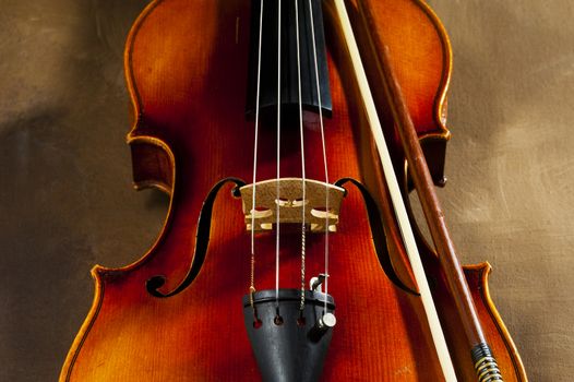 Vintage violin on old canvas background