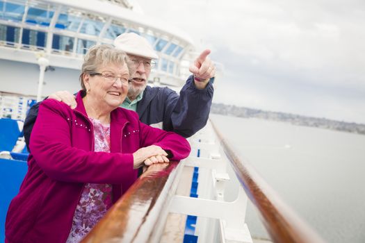 Happy Senior Couple Enjoying The View From Deck of a Luxury Passenger Cruise Ship.