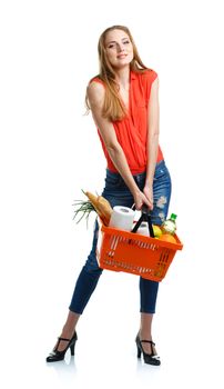 Happy young woman holding a basket full of healthy food. Shopping