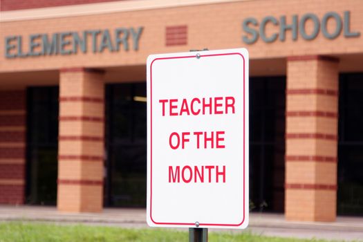 Teacher of the month parking sign in front of an elementary school.