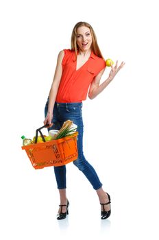 Happy young woman holding a basket full of healthy food. Shopping