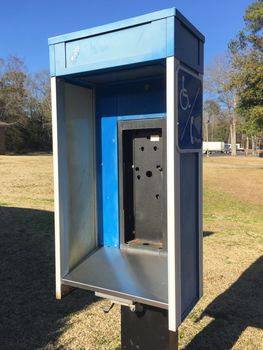 Abandoned public telephone booth.  Pay phones are increasingly being removed due to their low usage, having been replaced by cell phones.