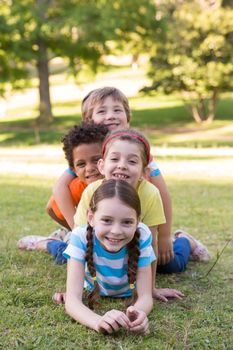 Little children smiling at camera on a sunny day