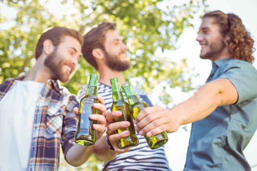 Hipster friends having a beer together on a summers day