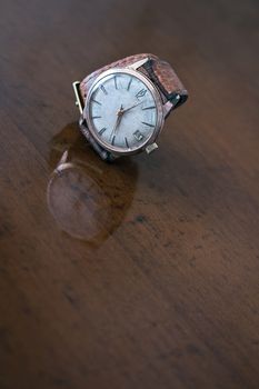 old wrist watch on a wooden base