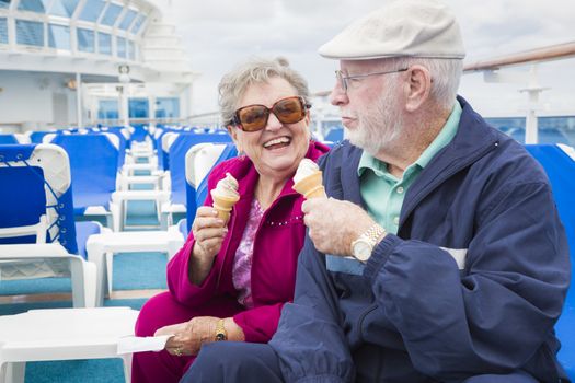 Happy Senior Couple Enjoying Ice Cream On The Deck of a Luxury Passenger Cruise Ship.