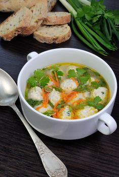 Easy chicken soup with meatballs, green onions and parsley