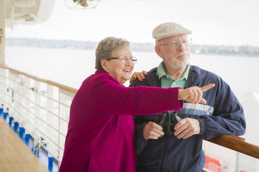 Happy Senior Couple Enjoying The View From Deck of a Luxury Passenger Cruise Ship.