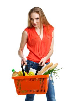 Happy young woman holding a basket full of healthy food. Shopping