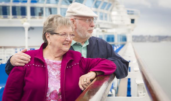 Happy Senior Couple Enjoying The View From Deck of a Luxury Passenger Cruise Ship.