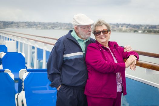 Happy Senior Couple Enjoying The View From Deck of a Luxury Passenger Cruise Ship.