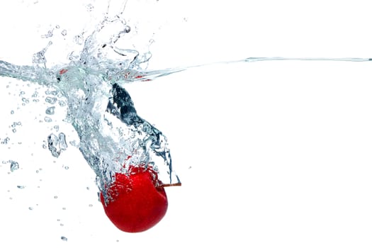 fresh red apple falls deeply under water with a splash isolated on white background