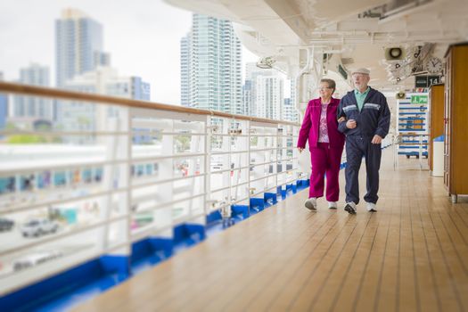 Happy Senior Couple Walking The Deck of a Luxury Passenger Cruise Ship.