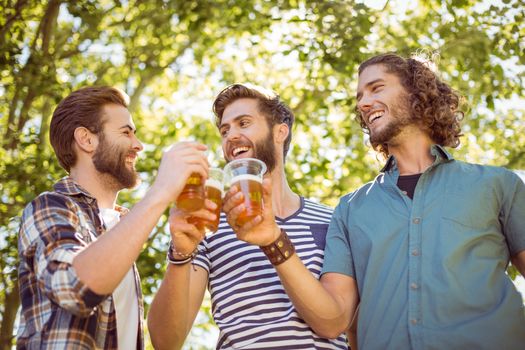 Hipster friends having a beer together on a summers day