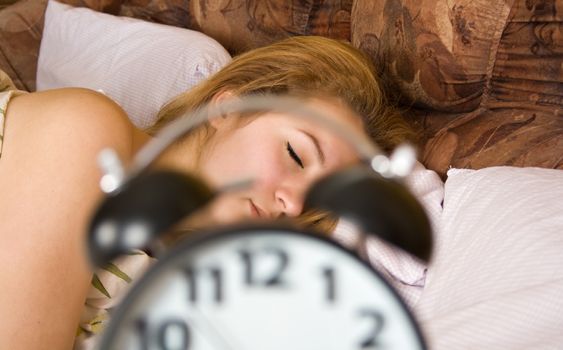 Young woman sleeping in bed in the morning.