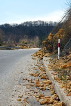 picture of a landslide of rocks on the asphalt road