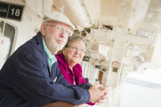 Happy Senior Couple Enjoying The View From Deck of a Luxury Passenger Cruise Ship.