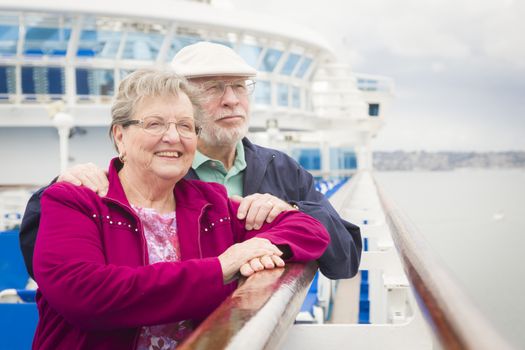 Happy Senior Couple Enjoying The View From Deck of a Luxury Passenger Cruise Ship.