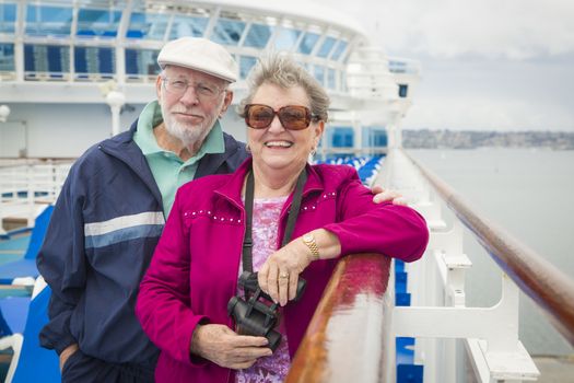 Happy Senior Couple Enjoying The View From Deck of a Luxury Passenger Cruise Ship.