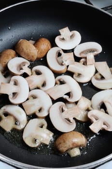 Fried sliced mushrooms in butter in a frying pan. For step by step recipe